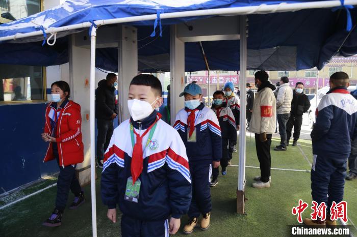 圖為學(xué)生測(cè)量體溫后進(jìn)入校園?！●R銘言 攝