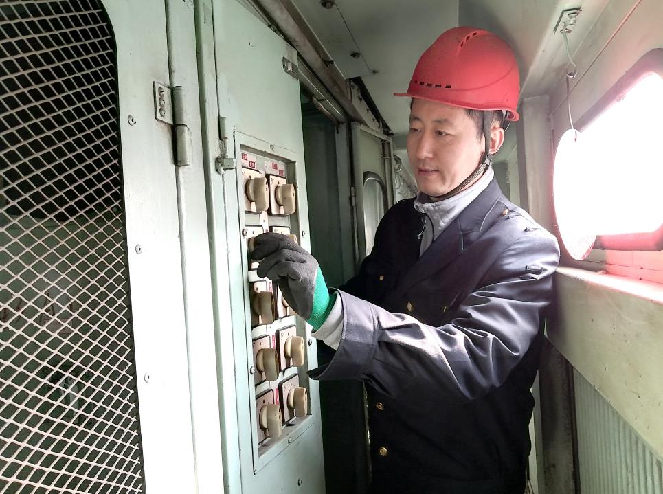 韓文盛認(rèn)真檢查低壓柜。