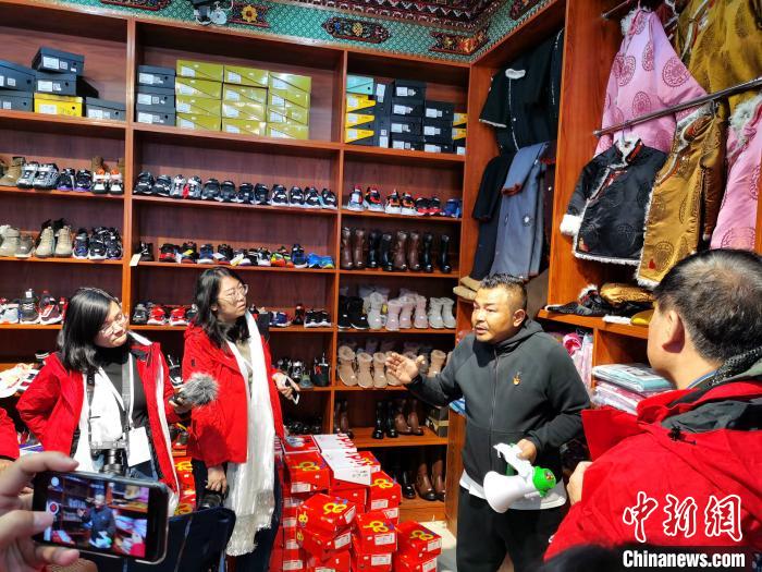 圖為中外媒體在玉樹州玉樹市甘達(dá)村采訪?！?zhí)砀?攝