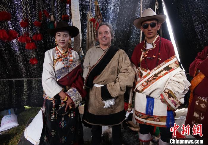 圖為一名外籍攝影師(中)身穿藏服和藏族民眾合影留念。　馬銘言 攝